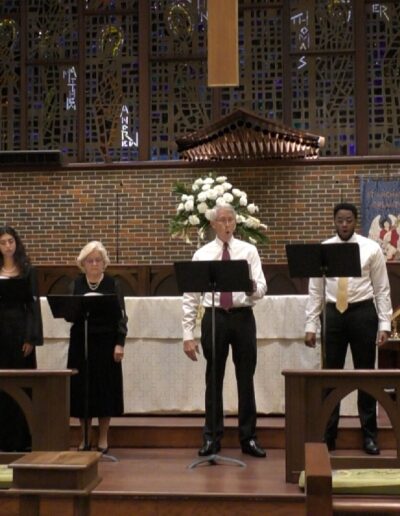 Andrew Walker conducting a singing group in church